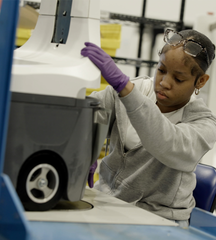 woman working on a robot